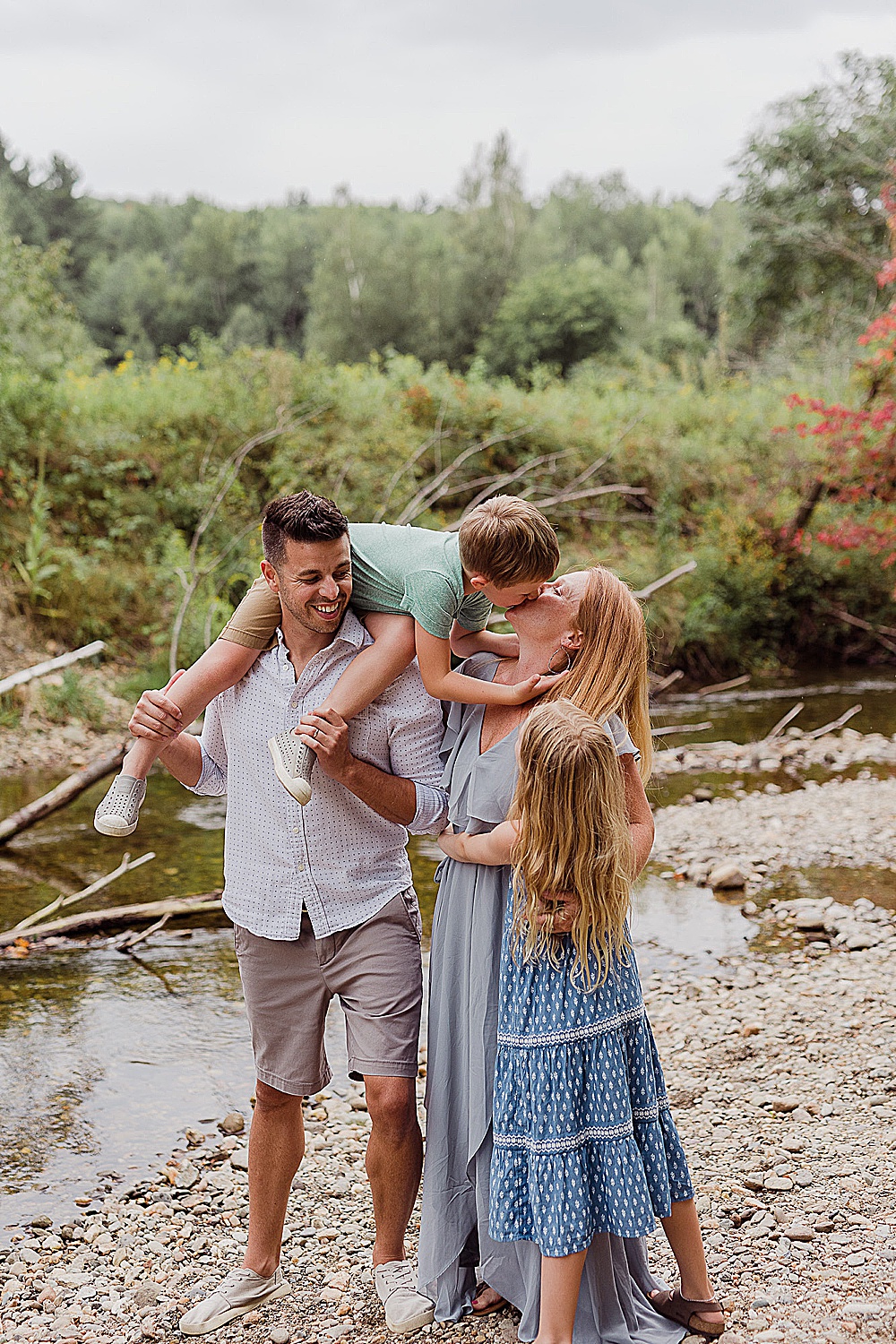 Vermont family posing along a Vermont river in summer